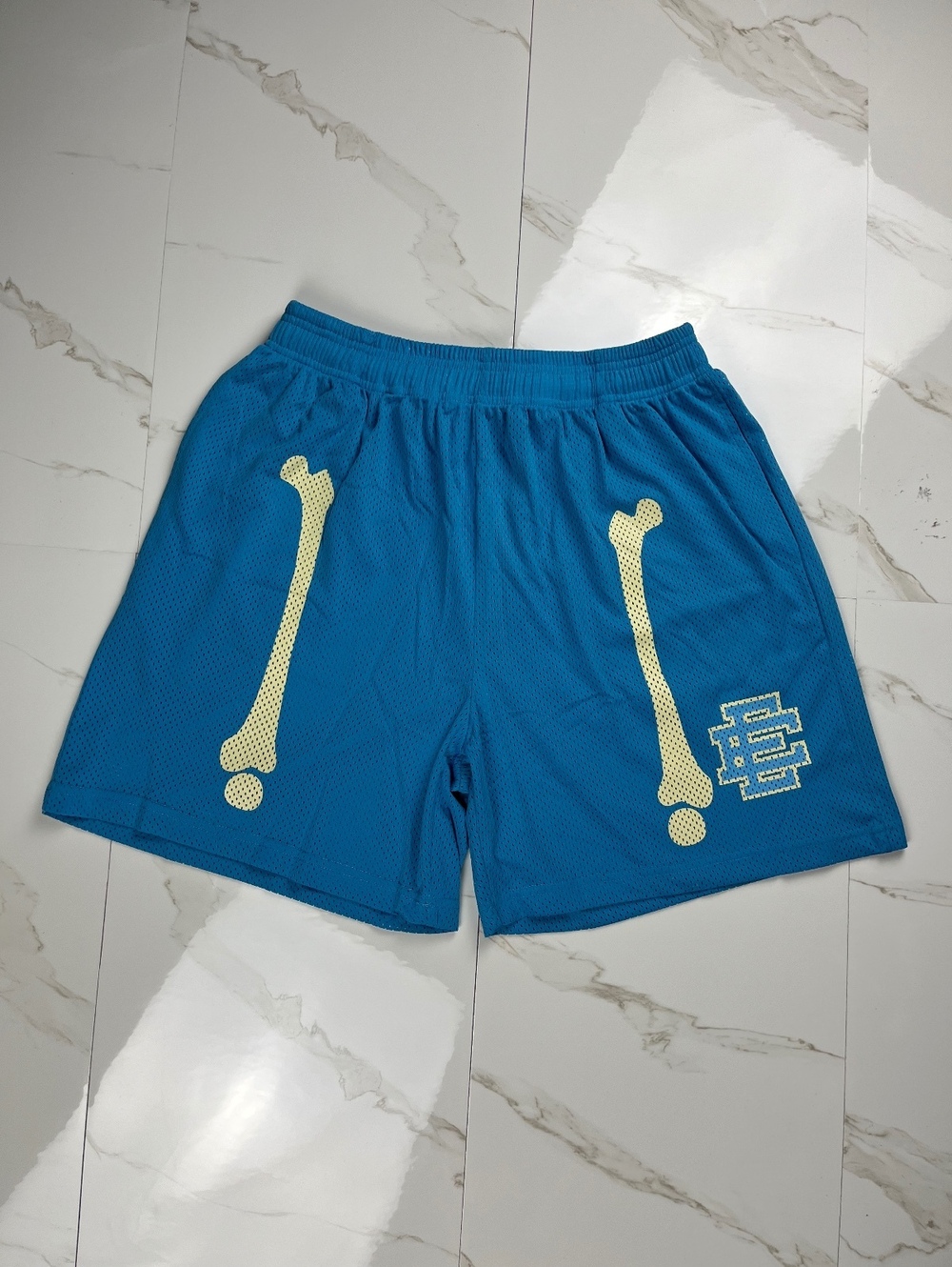 Eric Emanuel Blue Mesh Basketball Shorts with Bone Print